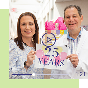 Jill T. and Dr. Schlessinger holding up a 25 years sign